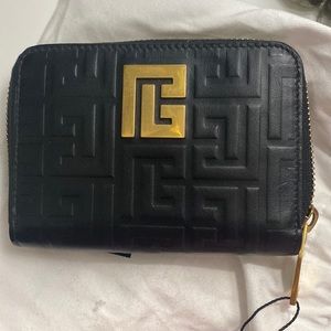 Balmain
Monogram-pattern zipped wallet